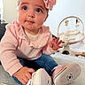 Adaline joined the competition — help win amazing prizes! baby, child, pink_headband, flower, sweater, jeans, baby_shoes, polka_dots, carpet, indoor, baby_swing, soft_light, cute, infant, sitting, tying_shoes, big_eyes, curious, portrait, closeup
