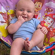 Tommy joined the competition — help win amazing prizes! baby, child, outdoor, grass, chair, paw_patrol, blue_onesie, smiling, happy, foot, hand, head, face, toy_chair, colorful, sunlight, nature, cute, infant, playful