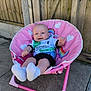 Tommy is registered to the contest to win money with this photo: baby, child, smiling, pink_chair, unicorn, hearts, socks, sports_jersey, outdoor, wooden_fence, concrete, happy, person, portrait, seated, infant, cute, casual_clothing, sunlight, daytime