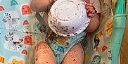 Tommy is registered to the contest to win money with this photo: animal_print, baby, baby_chair, bowl, child, chocolate, cute, eating, face, feet, floor, food, hands, happy, highchair, indoor, infant, legs, messy, playful
