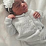 Wynter joined the competition — help win amazing prizes! newborn, baby, sleeping, white_outfit, headband, flower, blanket, soft_texture, cozy, infant, peaceful, closeup, portrait, indoors, resting, cute, small_hands, curly_hair, warm, comfortable