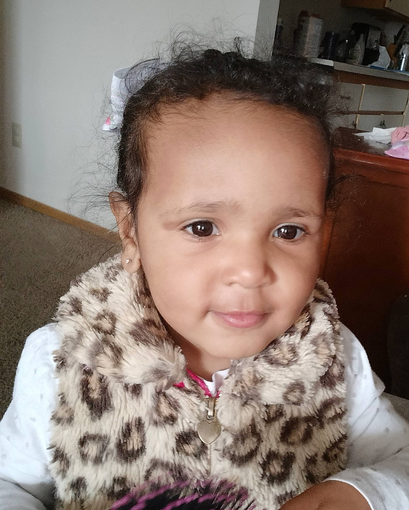 Jayla is registered to the contest to win money with this photo: baby_toddler_clothing, black_hair, cheek, child, ear, eye, eyebrow, eyelash, forehead, happy, head, iris, lip, neck, nose, person, sitting, skin, sleeve, smile