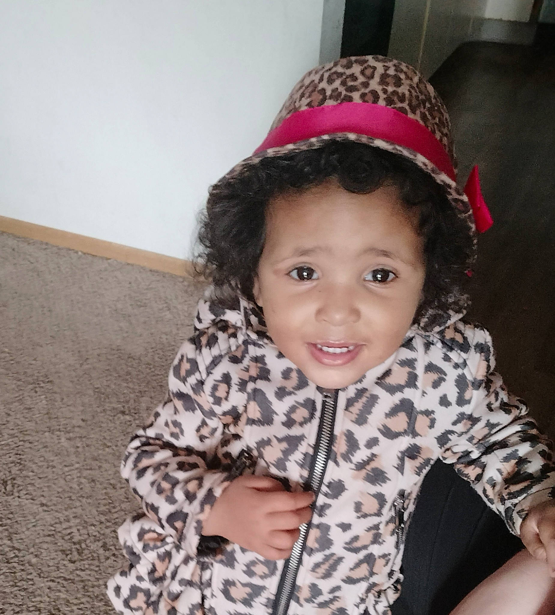 Jayla is registered to the contest to win money with this photo: baby_toddler_clothing, cap, cheek, child, cool, costume_hat, eyebrow, face, finger, fun, hair, happy, head, magenta, outerwear, pattern, person, skin, sleeve, smile