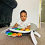 Kayce is registered to the contest to win money with this photo: toddler, child, toy, piano, colorful, carpet, cushion, indoor, white_wall, sofa, furniture, person, cute, playtime, music, floor, home, smiling, short_hair, bright