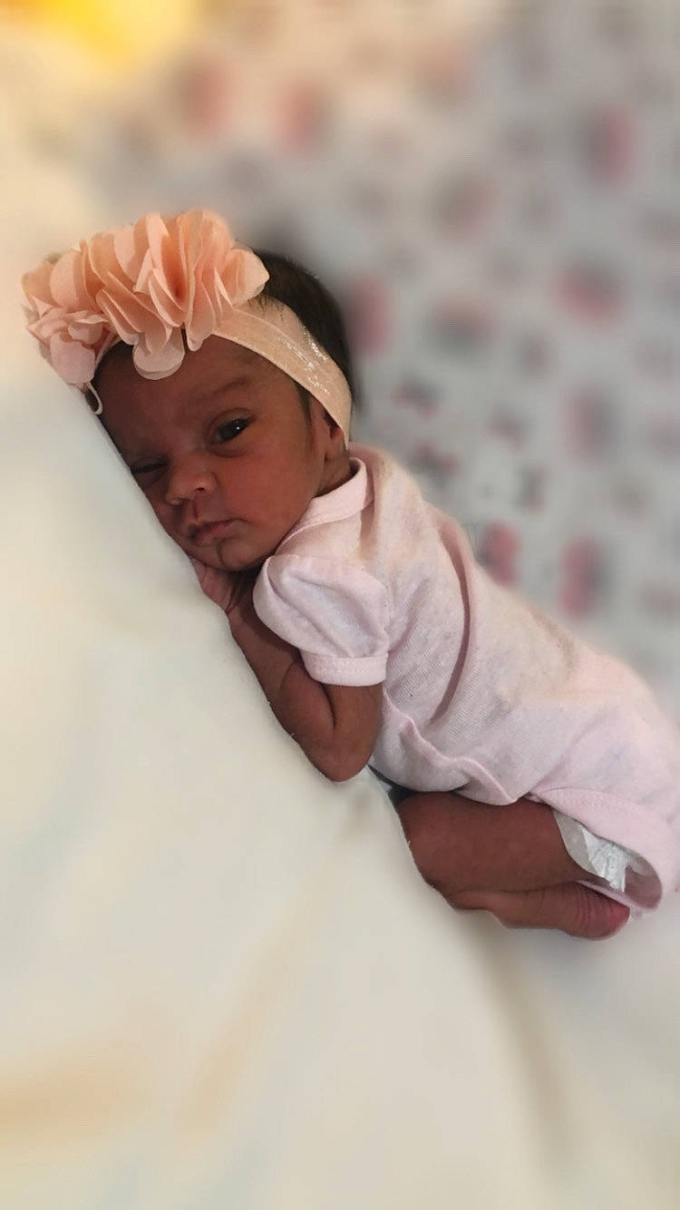 Everlee is registered to the contest to win money with this photo: baby, baby_sleeping, baby_toddler_clothing, beanie, child, comfort, fashion_accessory, flower, fur, gesture, headwear, linens, nail, peach, person, petal, portrait_photography, rose_family, rose_order, sleeve
