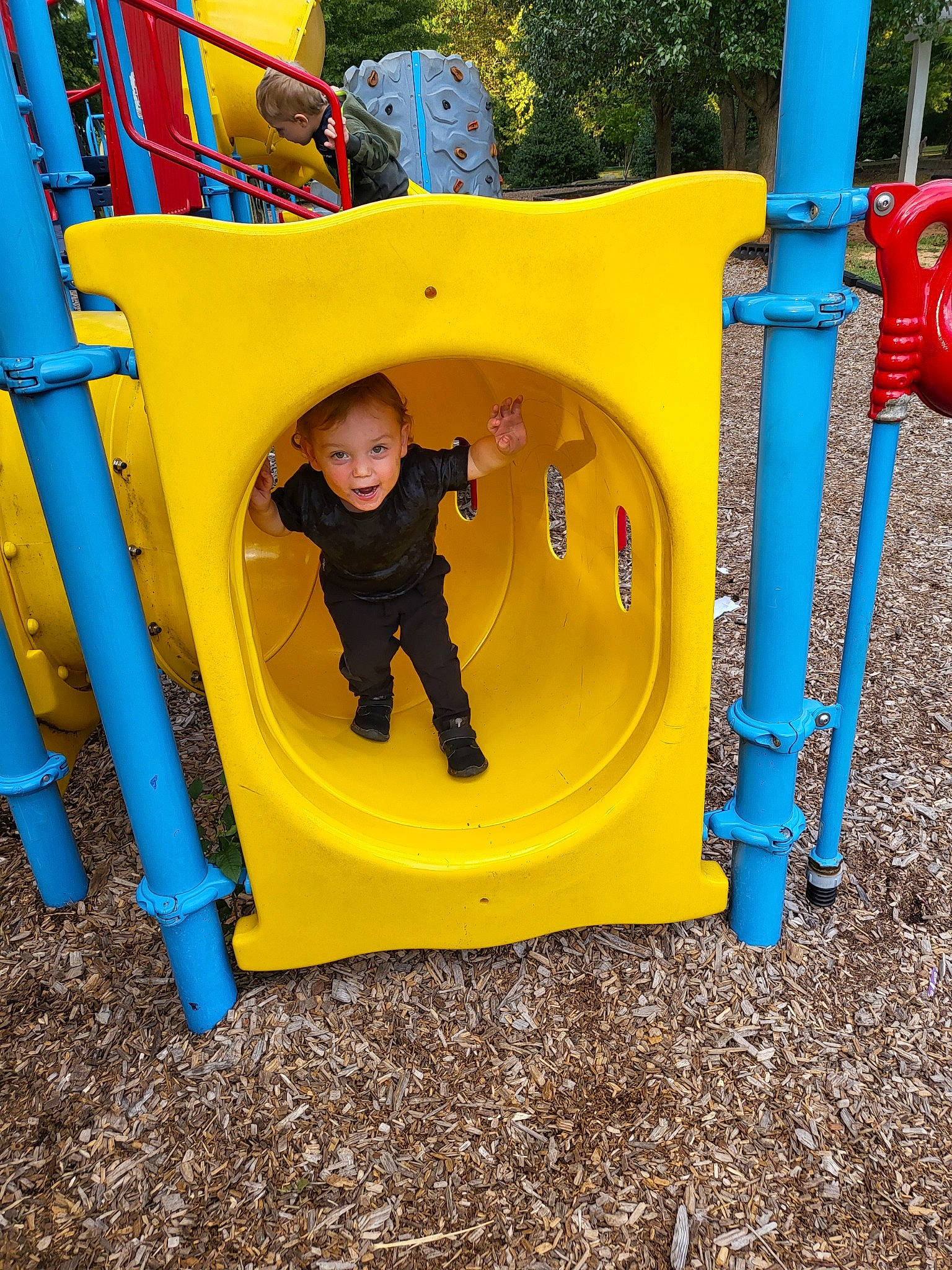 Joshua joined the competition — help win amazing prizes! baby_toddler_clothing, blue, child, chute, city, electric_blue, fun, grass, leisure, outdoor_play_equipment, person, play, playground, playground_slide, recreation, smile, t_shirt, toddler, yellow