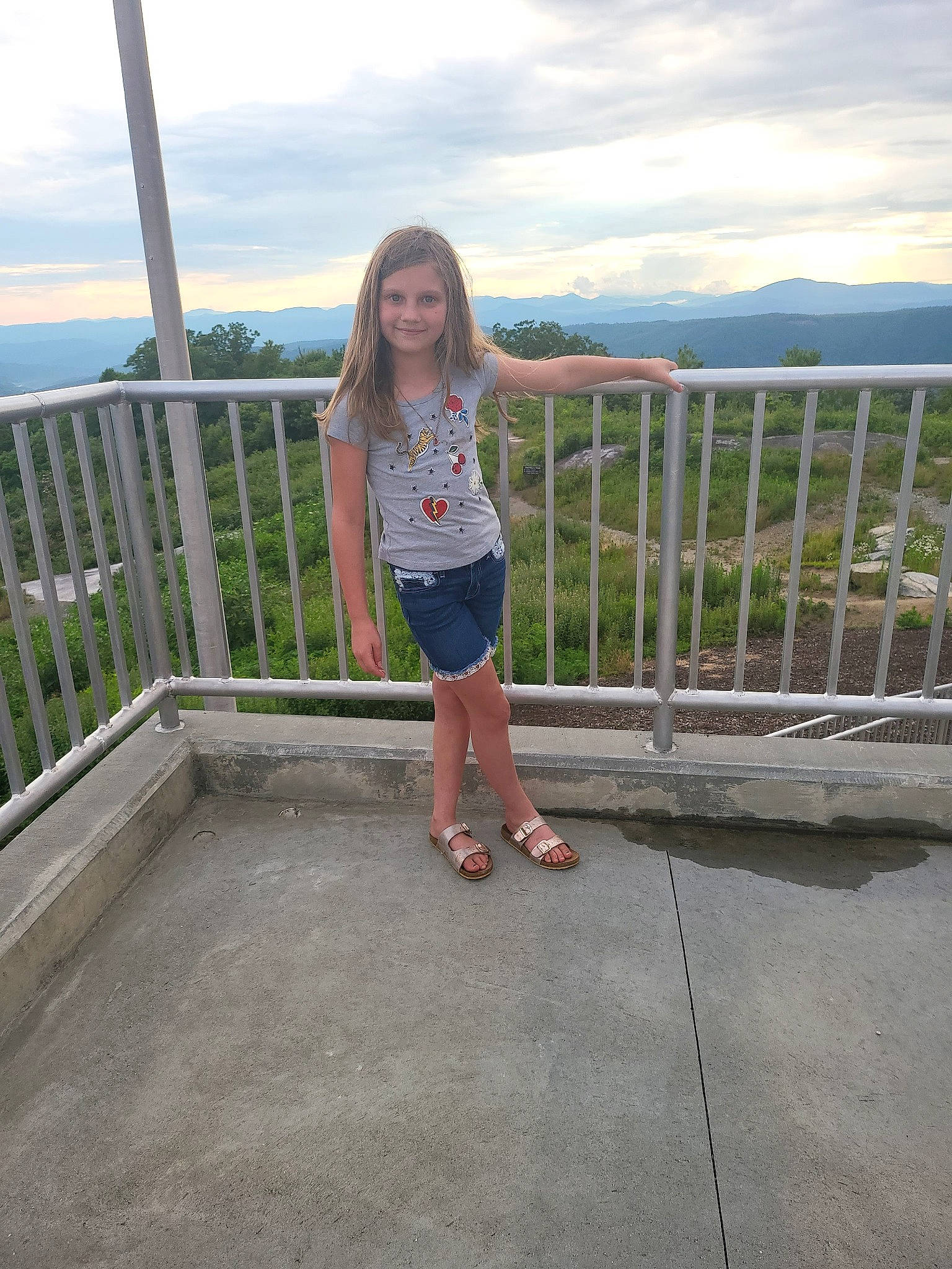 Bethany joined the competition — help win amazing prizes! body_of_water, cloud, fence, fun, grass, handrail, horizon, human_leg, joy, landscape, leisure, person, plant, recreation, shorts, sky, smile, standing, thigh, travel