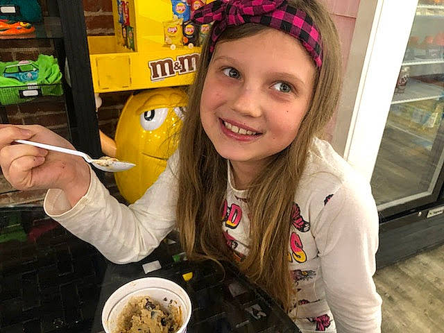 Bethany is registered to the contest to win money with this photo: cap, child, comfort_food, cuisine, dessert, dish, fashion_accessory, fast_food, food, fun, happy, headwear, joy, junk_food, person, shelf, smile, snack, spoon, tableware