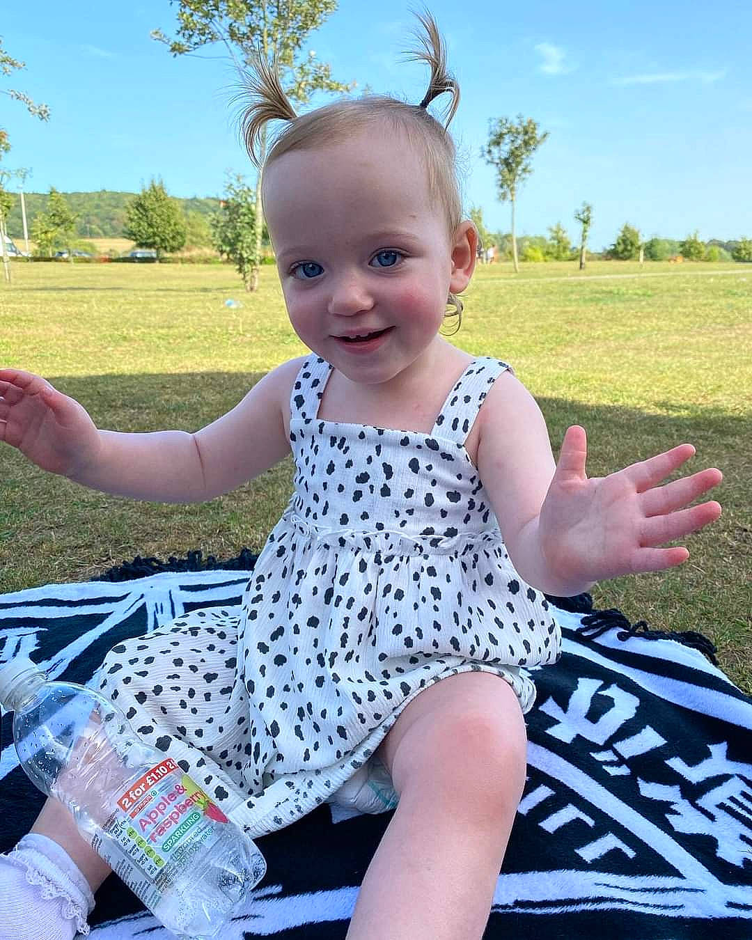 Amara is registered to the contest to win money with this photo: baby_toddler_clothing, beauty, child, facial_expression, finger, fun, grass, happy, joy, leisure, people, people_in_nature, person, pink, plant, sky, sleeve, smile, summer, toddler