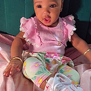 Teiaurie is registered to the contest to win money with this photo: baby, child, pink_clothing, floral_leggings, sneakers, headband, bracelet, blanket, seated, cute, indoors, portrait, jewelry, expression, soft_texture, footwear, fashion, adorable, infant, happy