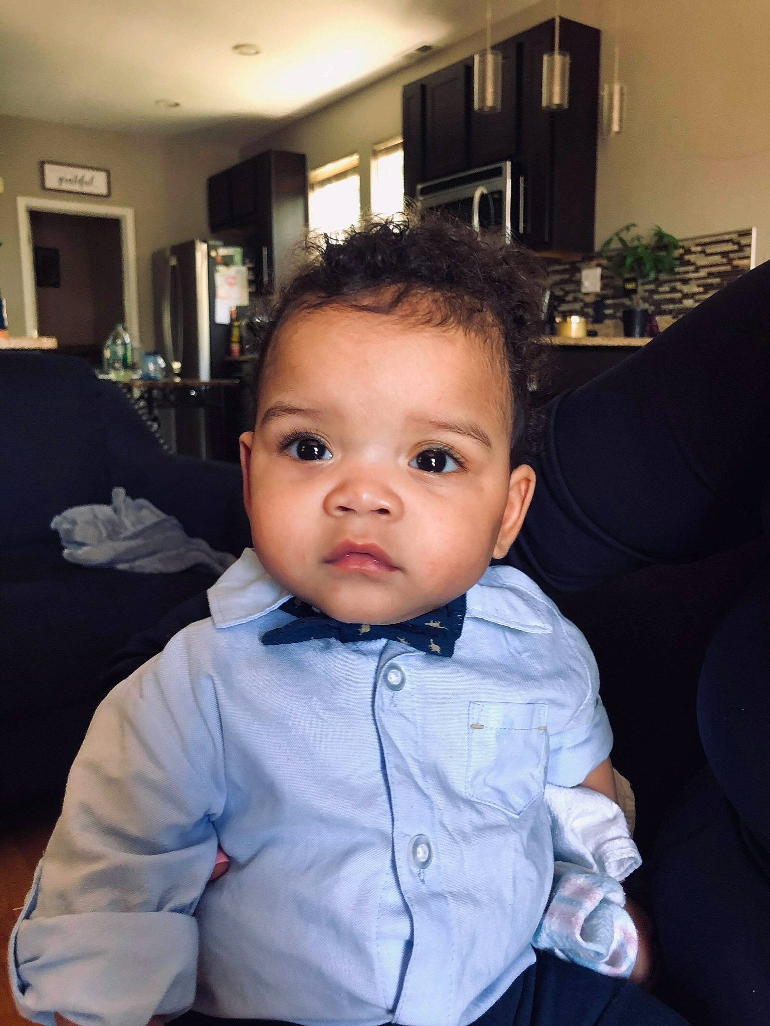 Emilio is registered to the contest to win money with this photo: baby, baby_toddler_clothing, cheek, child, collar, comfort, couch, eyelash, flash_photography, flooring, fun, happy, houseplant, lighting, person, picture_frame, plant, room, sitting, sleeve