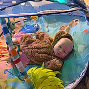 Spencer joined the competition — help win amazing prizes! baby, infant, plush_clothing, bear_costume, play_gym, colorful, toys, sea_creatures, octopus, turtle, fish, carpet, indoor, child, cute, portrait, soft_toys, baby_toy, baby_mat, young_child