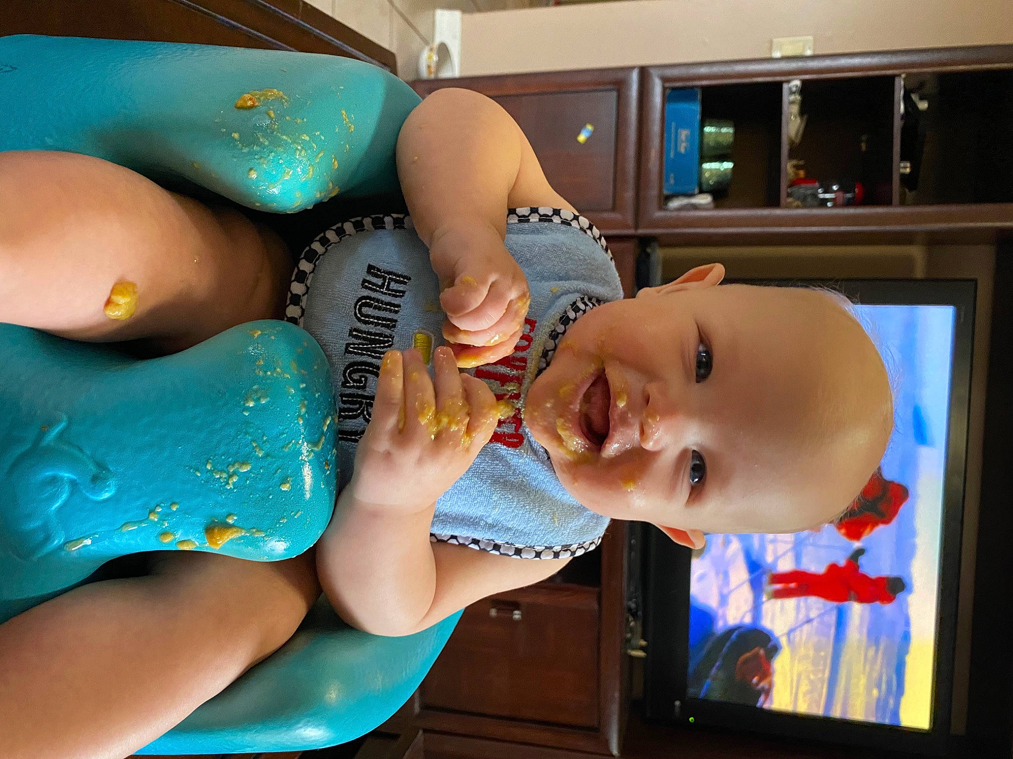 Jackson is registered to the contest to win money with this photo: baby, blue, chest, child, electric_blue, eye, eyelash, finger, fun, gesture, happy, head, human_body, leisure, mouth, person, skin, smile, television, toddler