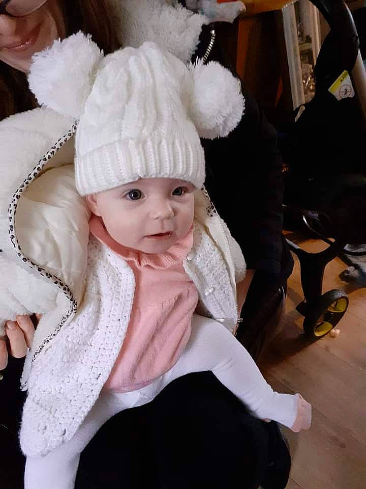 Ellie joined the competition — help win amazing prizes! art, baby, baby_toddler_clothing, cap, costume_hat, event, fashion_accessory, fashion_design, fur, fur_clothing, hair_accessory, headgear, headwear, knit_cap, person, street_fashion, toddler, tradition, white, winter