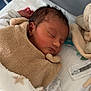 Hanouk participe au concours pour gagner de l'argent avec cette photo : newborn, baby, sleeping, blanket, hospital, bassinet, plush_toy, cozy, infant, peaceful, soft_lighting, wrapped, bed, clothing, person, young_child, cute, indoor, portrait, resting