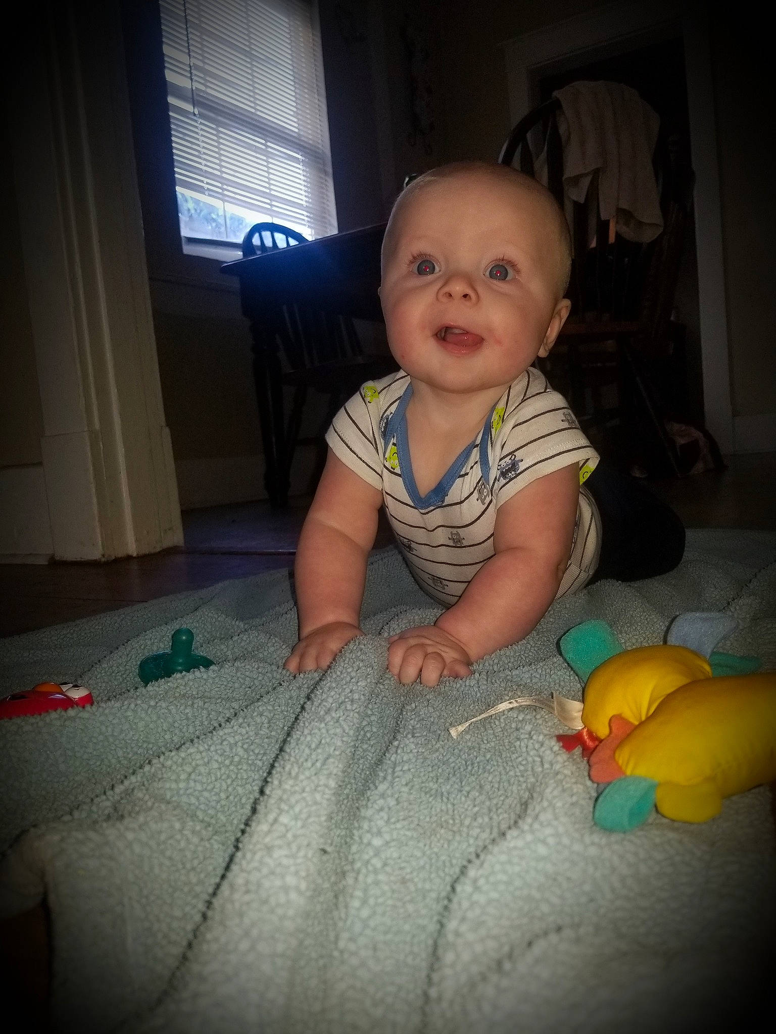 Homer is registered to the contest to win money with this photo: baby, baby_toddler_clothing, cheek, chin, finger, flash_photography, floor, flooring, happy, head, iris, lighting, mouth, nose, person, product, skin, smile, standing, window