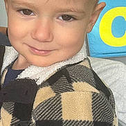 Dylan Joseph is registered to the contest to win money with this photo: brown_hair, checkered, child, closeup, clothing, cute, expression, eyes, face, fashion, happy, head, indoor, jacket, person, portrait, skin, smile, warm, young