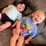 Laken joined the competition — help win amazing prizes! baby, toddler, child, couch, sofa, clothing, headband, black_bow, blue_tshirt, rolling_stones, smiling, happy, indoor, furniture, feet, legs, cute, people, sitting, relaxed