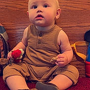 Laken joined the competition — help win amazing prizes! baby, buttoned_shirt, carpet, casual_clothing, child, curious, face, footwear, home_decor, indoor, light, moawk, person, plush_toy, red_carpet, shorts, sitting, snack, toy, wooden_panel