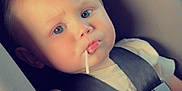 Laken is registered to the contest to win money with this photo: baby, blue_eyes, car, car_seat, child, clothing, cute, face, hair, indoor, infant, lollipop, person, portrait, restraint, safety, seat, seatbelt, transportation, young_child