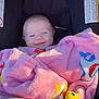 Journii is registered to the contest to win money with this photo: baby, blanket, car_seat, chicco, child, smiling, face, infant, pink, plush, cute, happy, baby_clothing, seat, child_seat, indoor, portrait, young_child, comfort, colorful