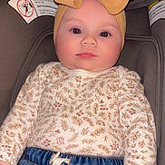 Journii joined the competition — help win amazing prizes! baby, child, headband, bow, car_seat, denim, pants, long_sleeve, floral_pattern, clothing, infant, cute, chubby_cheeks, face, hand, indoors, warning_label, seat, portrait, young_child