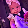 Journii is registered to the contest to win money with this photo: baby, infant, car_seat, blanket, headband, pink_bow, clothing, child, seatbelt, cute, face, arm, hand, indoor, soft_lighting, portrait, comfort, young_child, candid, expression
