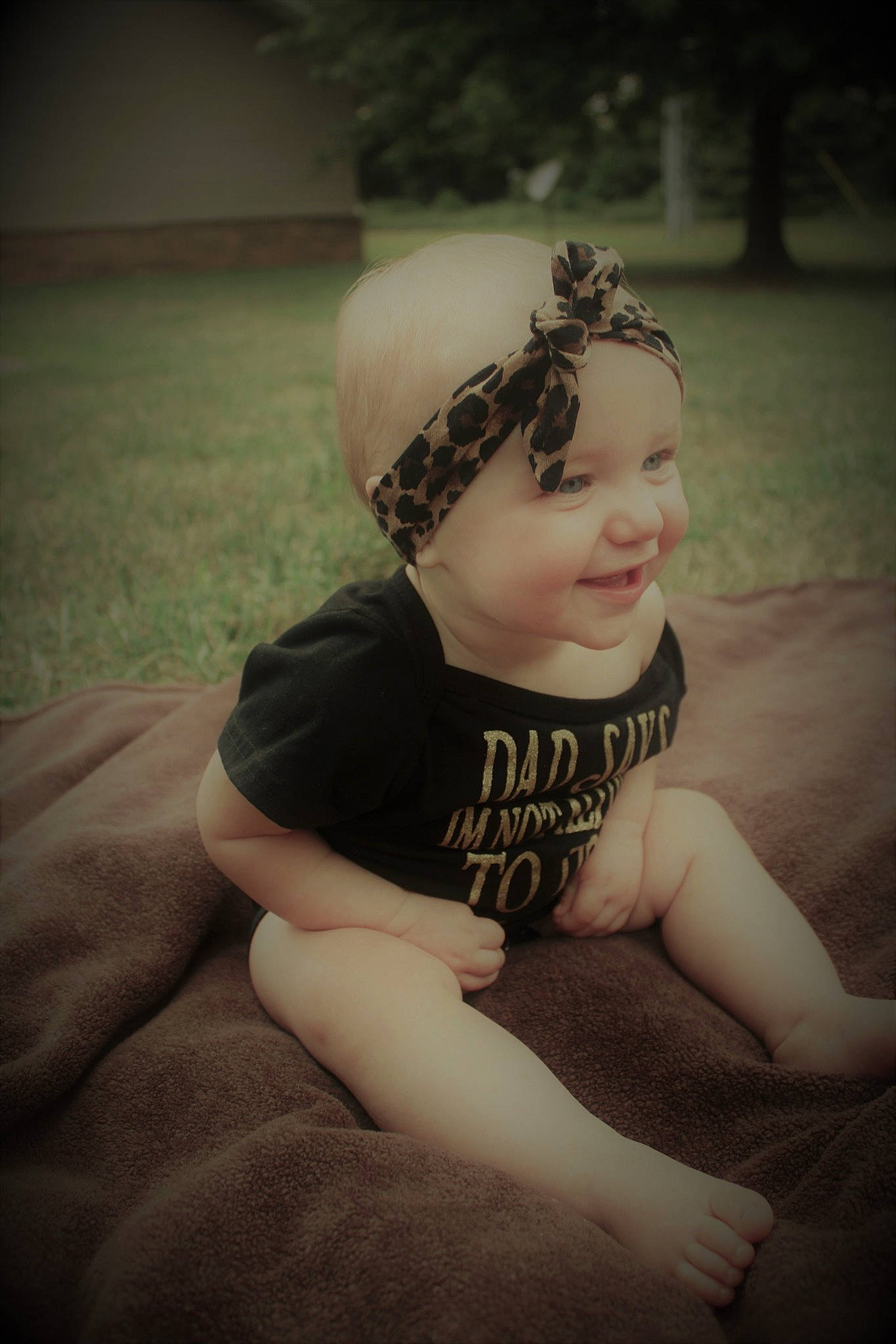 Emerald is registered to the contest to win money with this photo: baby, beauty, cheek, child, eye, face, fashion_accessory, fun, hair_accessory, hand, head, headgear, headpiece, headwear, joy, leg, lip, person, photography, sitting