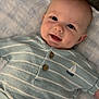 Jace is registered to the contest to win money with this photo: baby, infant, smiling, face, eyes, clothing, striped_shirt, buttons, sailboat, blanket, lying_down, cute, happy, portrait, child, soft_texture, indoors, young, person, head