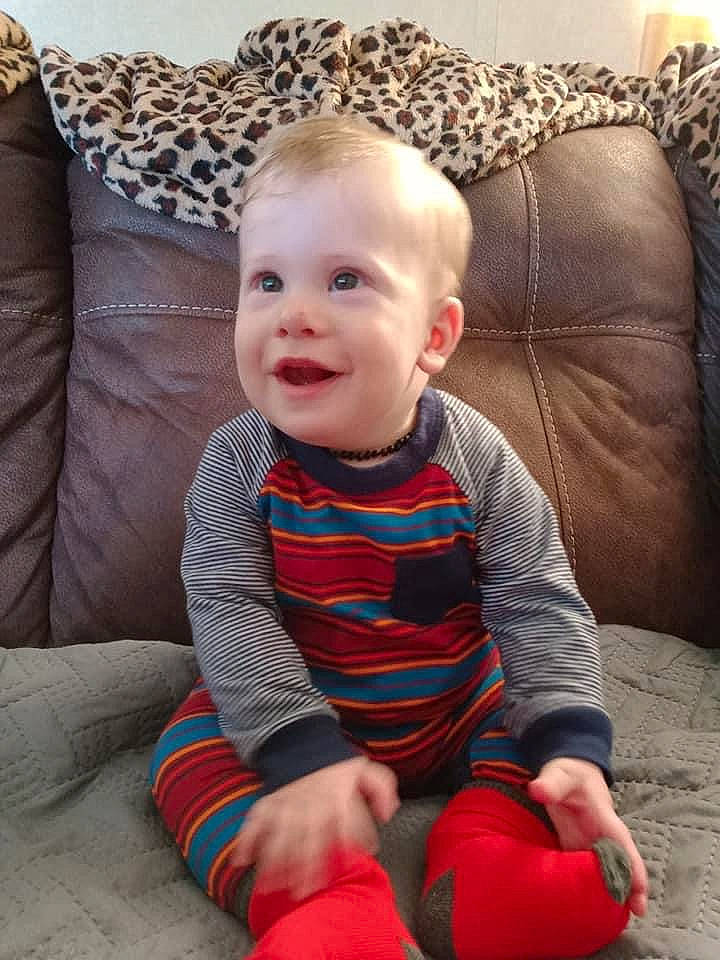 Landen is registered to the contest to win money with this photo: baby, baby_toddler_clothing, cheek, child, comfort, couch, eye, face, finger, floor, flooring, head, human_body, person, product, skin, sleeve, smile, textile, toddler