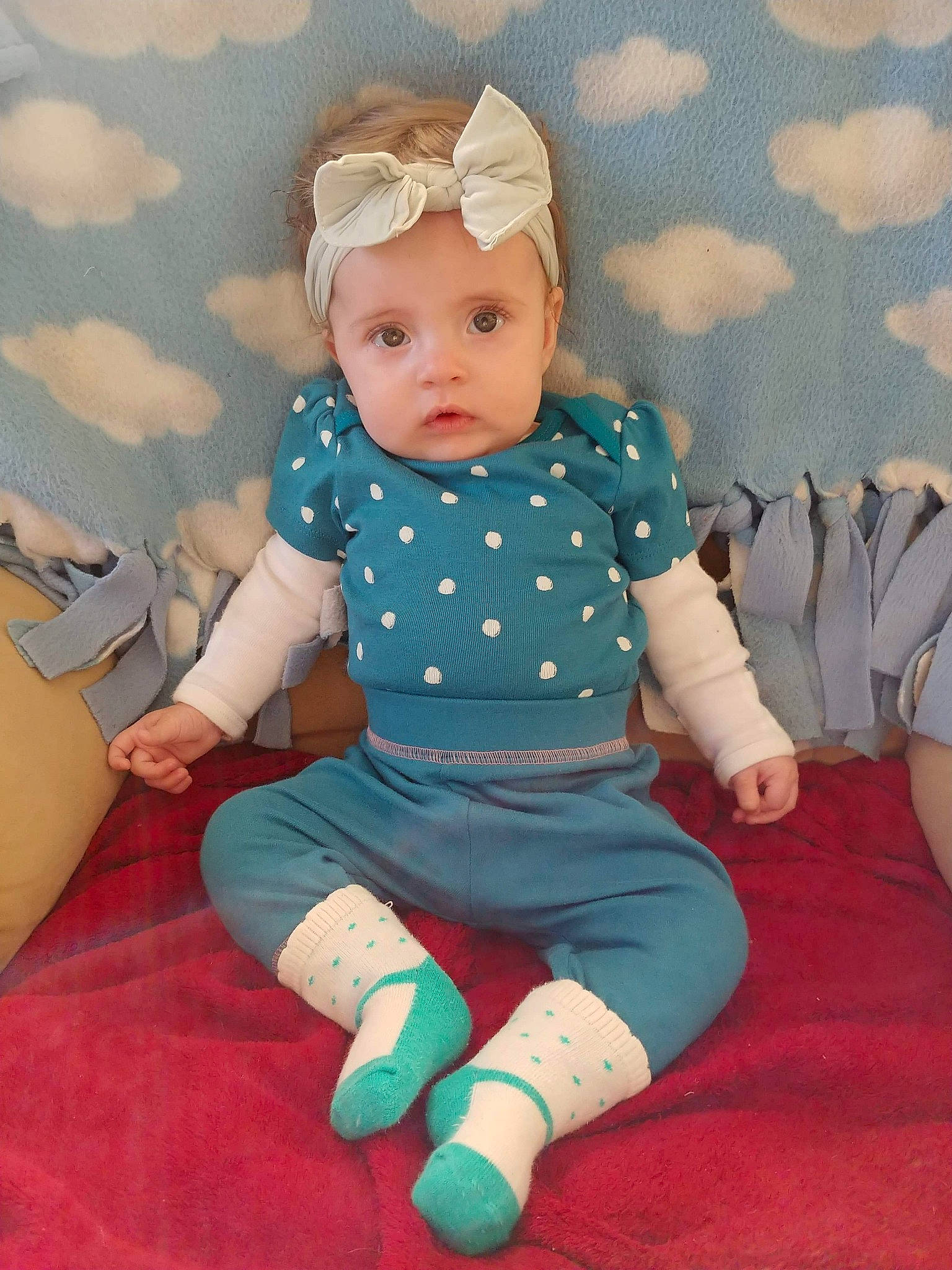 Shelby is registered to the contest to win money with this photo: baby_products, cheek, child, doll, girl, headgear, human_hair_color, infant, pattern, person, pink, play, product, sitting, skin, smile, textile, toddler, toy