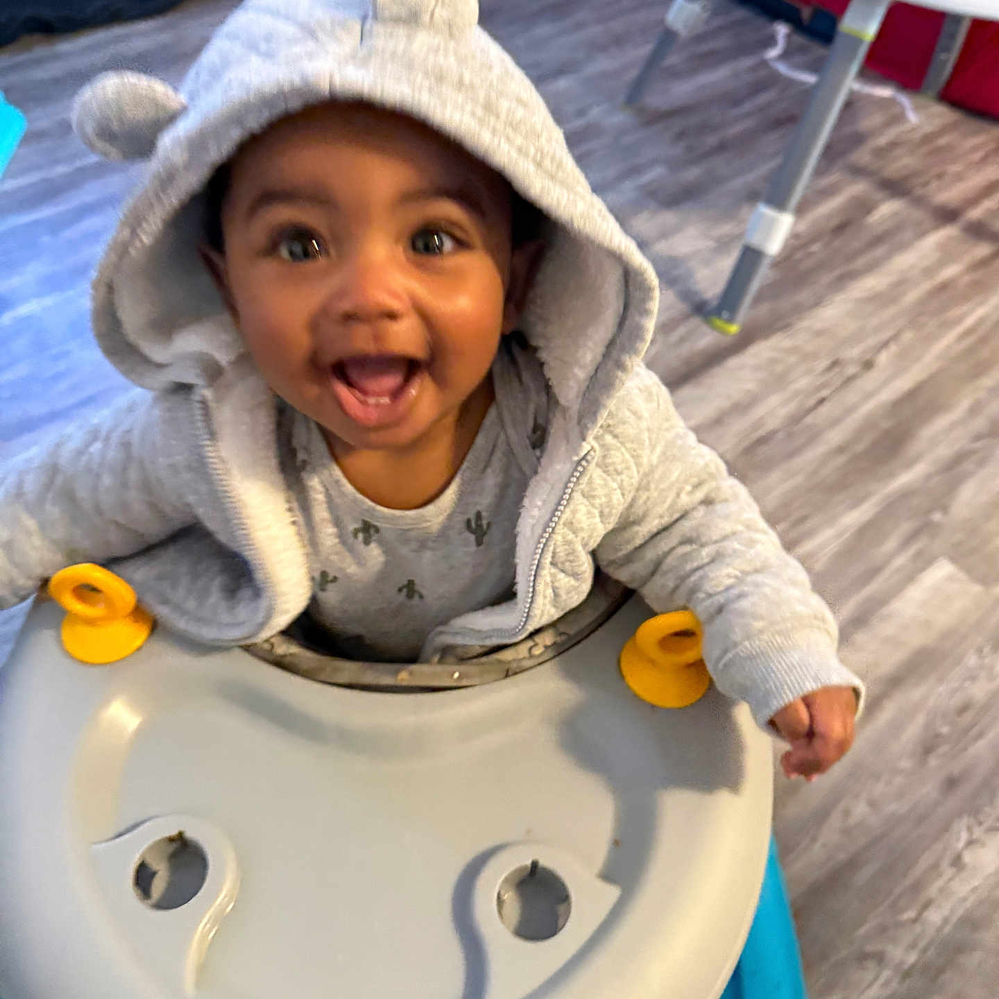 Abel Tru is registered to the contest to win money with this photo: baby, child, clothing, cute, ears, face, flooring, furniture, happy, home, hood, hoodie, indoor, infant, joy, person, play, smiling, toy, walker