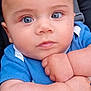 arm, baby, blue_eyes, casual, child, close_up, clothing, curious, cute, expression, face, human, indoor, infant, person, portrait, sitting, skin, soft_light, young