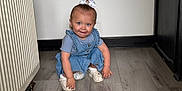Paisley joined the competition — help win amazing prizes! blue_dress, cabinet, child, crouching, cute, floor, hair, home, indoor, light, person, playful, radiator, shoes, skin, smiling, toddler, white_bow, wooden_floor, young_child