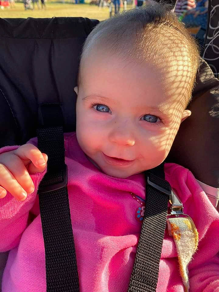 Nora is registered to the contest to win money with this photo: baby, baby_toddler_clothing, cheek, child, cool, ear, eyebrow, eyelash, finger, hand, happy, lip, nose, person, product, seat_belt, skin, sleeve, smile, thumb