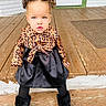 Zahra Harris is registered to the contest to win money with this photo: black_skirt, black_tights, boots, casual_clothing, child, curious_expression, cute, daylight, door, double_buns, fashion, front_steps, hairstyle, outdoor, patterned_shirt, porch, sitting, toddler, wooden_floor, young_child