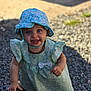 Kécya a rejoint le concours — aidez-le/la à gagner de superbes lots ! baby, blue_eyes, child, cute, dress, floral_dress, floral_hat, fun, gravel, happy, hat, headwear, outdoor, person, playful, portrait, smiling, sunlight, toddler, young_child