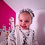 toddler, child, smiling, headband, vest, white_clothing, blue_eyes, indoor, portrait, happy, cute, baby, fashion, blurry_background, magenta_wall, person, face, apparel, female, infant