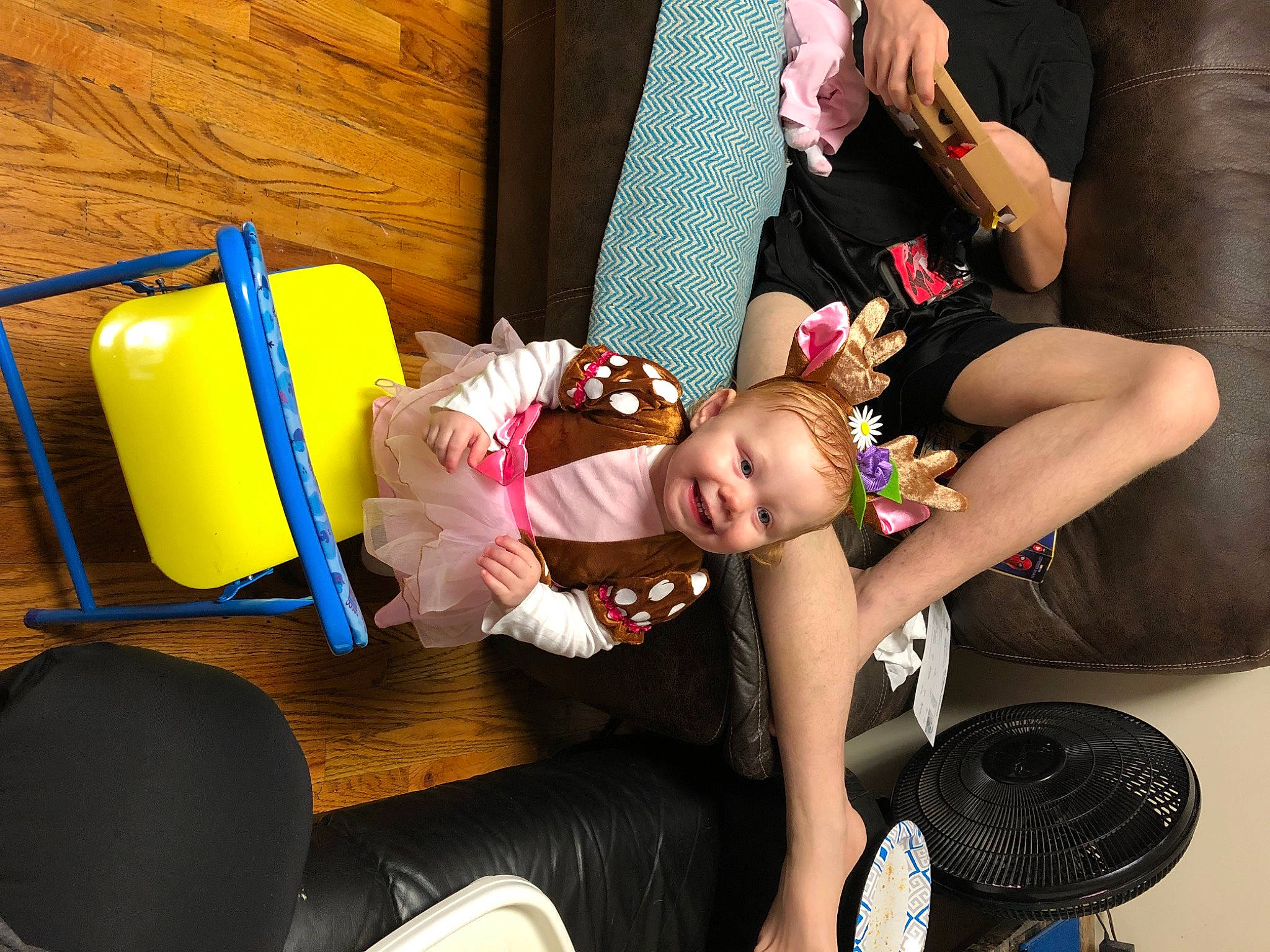 Lillian is registered to the contest to win money with this photo: baby, baby_products, chair, child, comfort, foot, fun, happy, human_leg, joy, knee, lap, leisure, mechanical_fan, person, play, room, sandal, sitting, sock