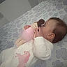 Leah is registered to the contest to win money with this photo: baby, infant, sleeping, lying_down, plush_toy, bunny, bed, floral_bedding, bedroom, indoors, portrait, child, face, earring, white_clothing, pink_clothing, cuddling, cozy, nap, soft_lighting