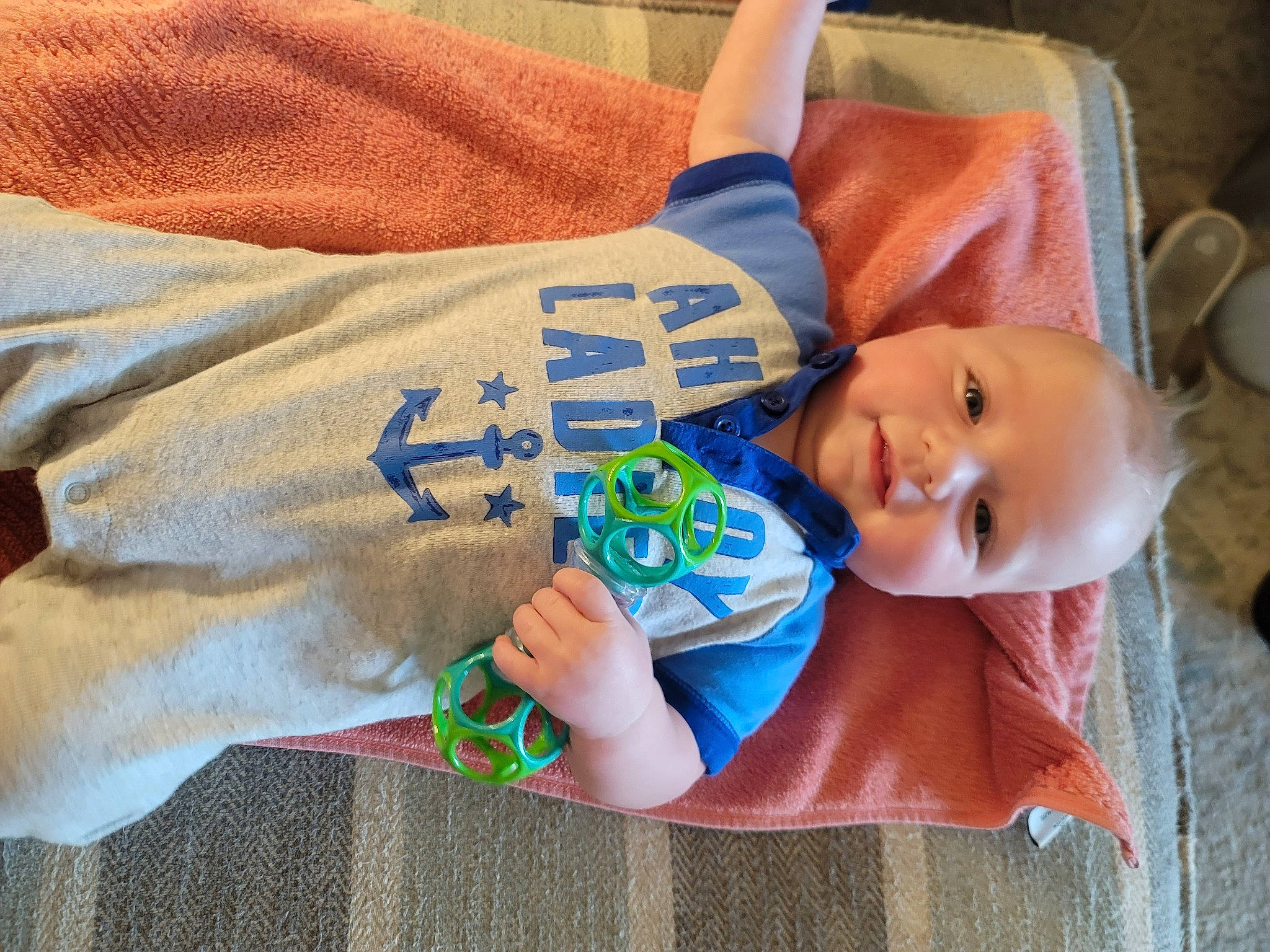 Lucas joined the competition — help win amazing prizes! baby, baby_toddler_clothing, child, comfort, elbow, electric_blue, finger, flooring, fun, grass, happy, linens, pattern, person, sitting, sleeve, smile, t_shirt, toddler, wood