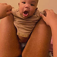 Kahlon is registered to the contest to win money with this photo: baby, body_part, casual, child, closeup, clothing, comfort, expression, face, hands, holding, human, indoor, infant, legs, light, person, skin, surprised, warm_tone