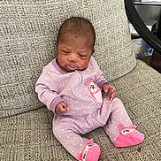 Royalty joined the competition — help win amazing prizes! baby, child, couch, cute, expression, face, footwear, furniture, head, indoors, infant, onesie, person, pink, polka_dot, purple_clothing, sitting, slippers, small_hands, young