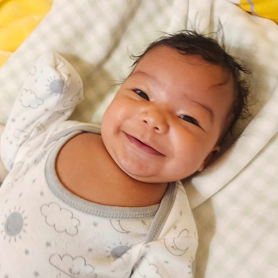 Miosoty joined the competition — help win amazing prizes! baby, bed, blanket, child, cozy, cute, face, happy, head, indoors, infant, lying_down, onesie, patterned_clothing, portrait, skin, sleepwear, smiling, soft, young