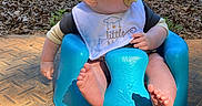 Kyle is registered to the contest to win money with this photo: baby, pacifier, blue_baby_seat, bib, outdoor, sunlight, leaves, wooden_beams, curious, infant, child, sitting, foot, hand, clothing, face, head, cute, young_child, portrait
