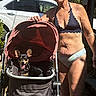 Lillie Belle joined the competition — help win amazing prizes! dog, stroller, woman, bikini, outdoor, sunlight, car, sidewalk, greenery, pet, happy, canine, smiling, summer, leisure, walking, retired, senior, vacation, fun