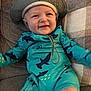 Cameron joined the competition — help win amazing prizes! baby, child, smile, hat, swimsuit, shark_pattern, couch, pillow, blue, turquoise, happy, infant, sitting, indoor, face, person, clothing, cute, young, cozy