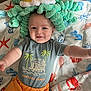Cameron is registered to the contest to win money with this photo: baby, child, plush, octopus, hat, tropical_vibes, shirt, orange_pants, blanket, sea_theme, crab, starfish, shell, smiling, happy, cute, indoor, person, infant, playful