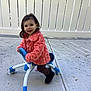 Isabella is registered to the contest to win money with this photo: toddler, child, walker, outdoor, concrete, fence, jacket, coral, blue, white, toy, play, smile, happy, person, feet, clothing, young_child, daylight, casual