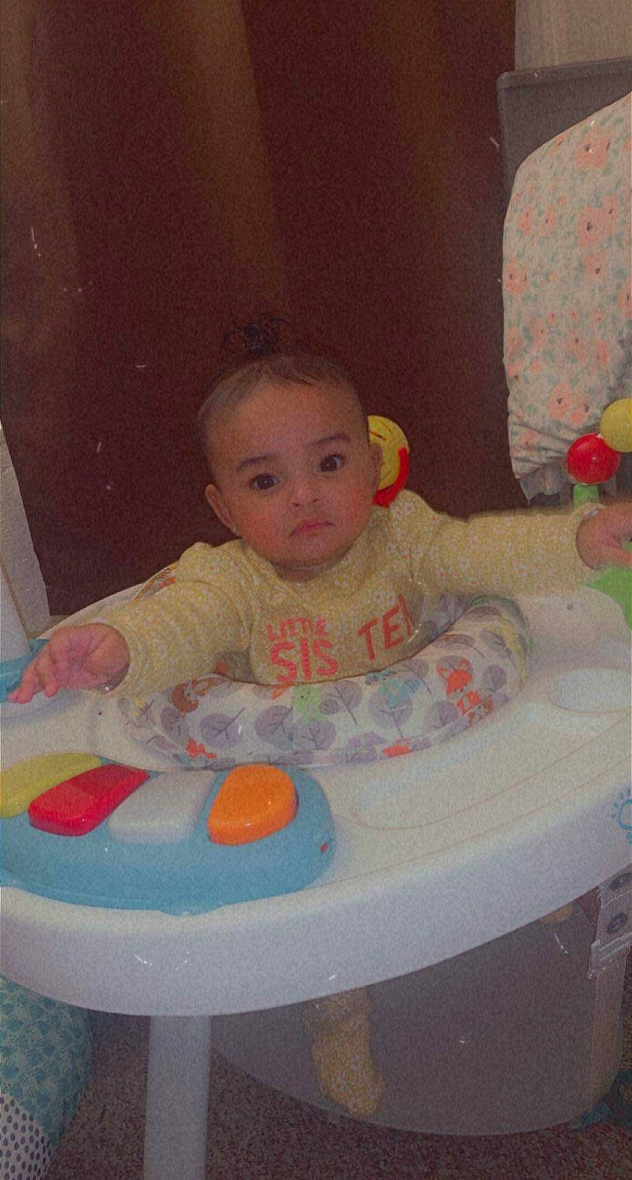 Amya is registered to the contest to win money with this photo: arm, baby, baby_playing_with_toys, baby_products, baby_safety, baby_toddler_clothing, baby_toys, bathing, bib, chair, cheek, child, comfort, fun, iris, mouth, person, play, sitting, skin